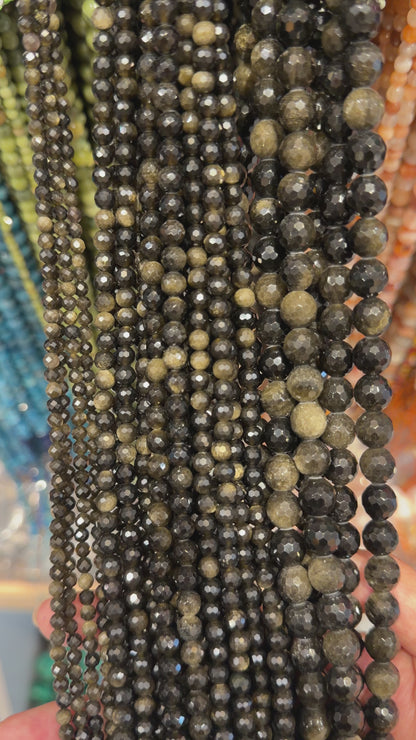 Strand of faceted gilded obsidian beads